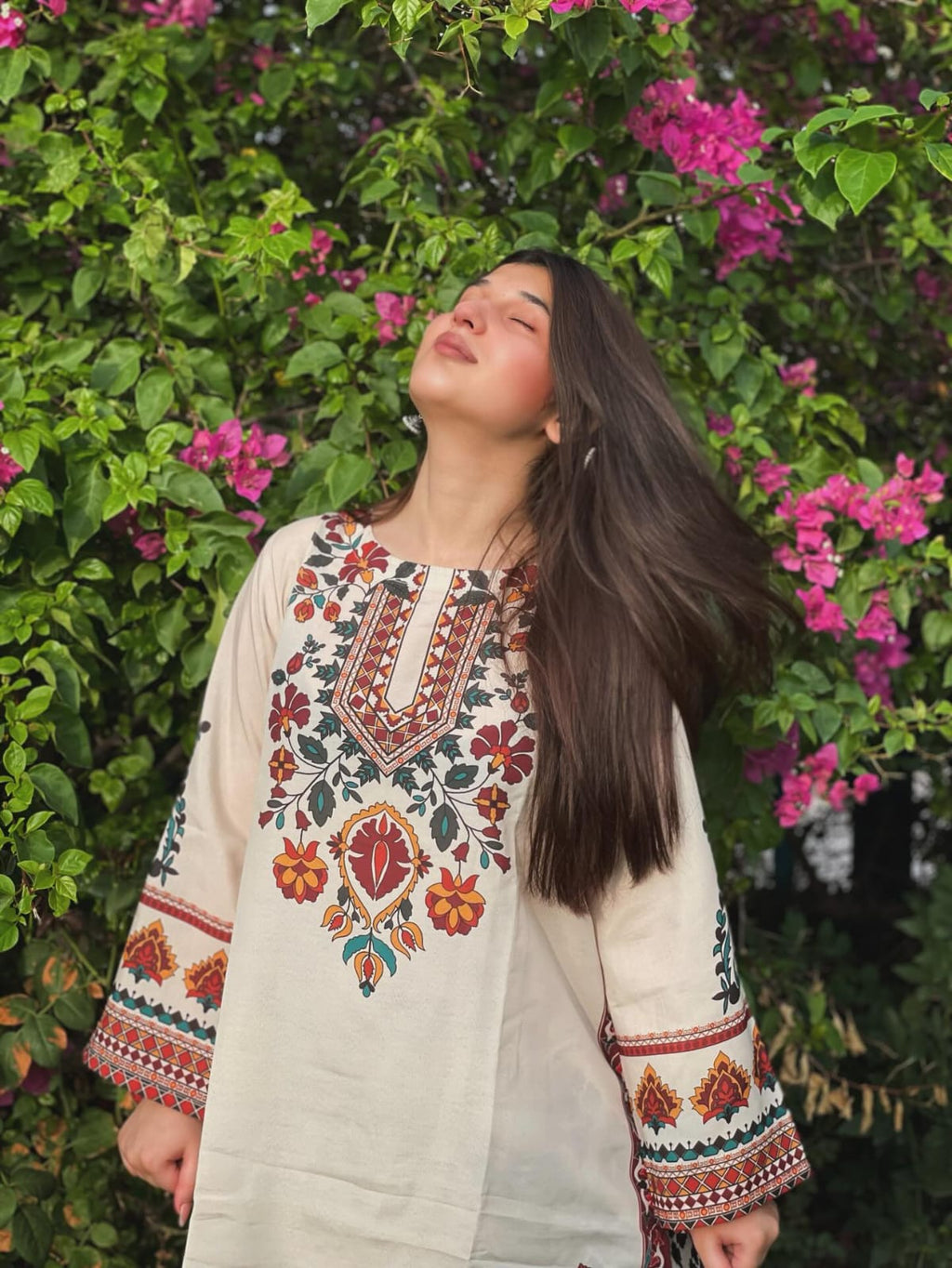 Woman in Floral Embroidered Kurti by a Pond