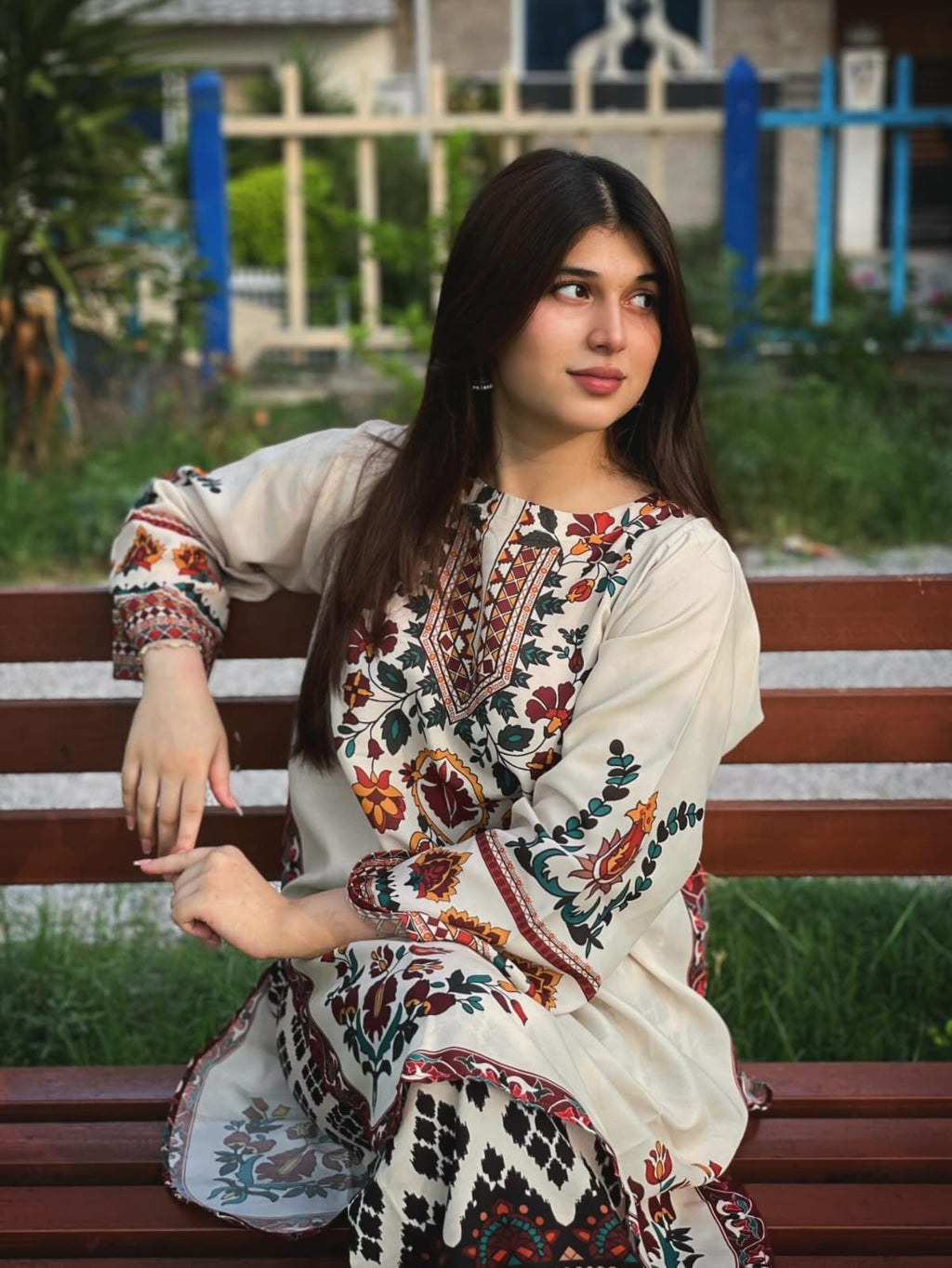 Woman in Floral Embroidered Kurti by a Pond