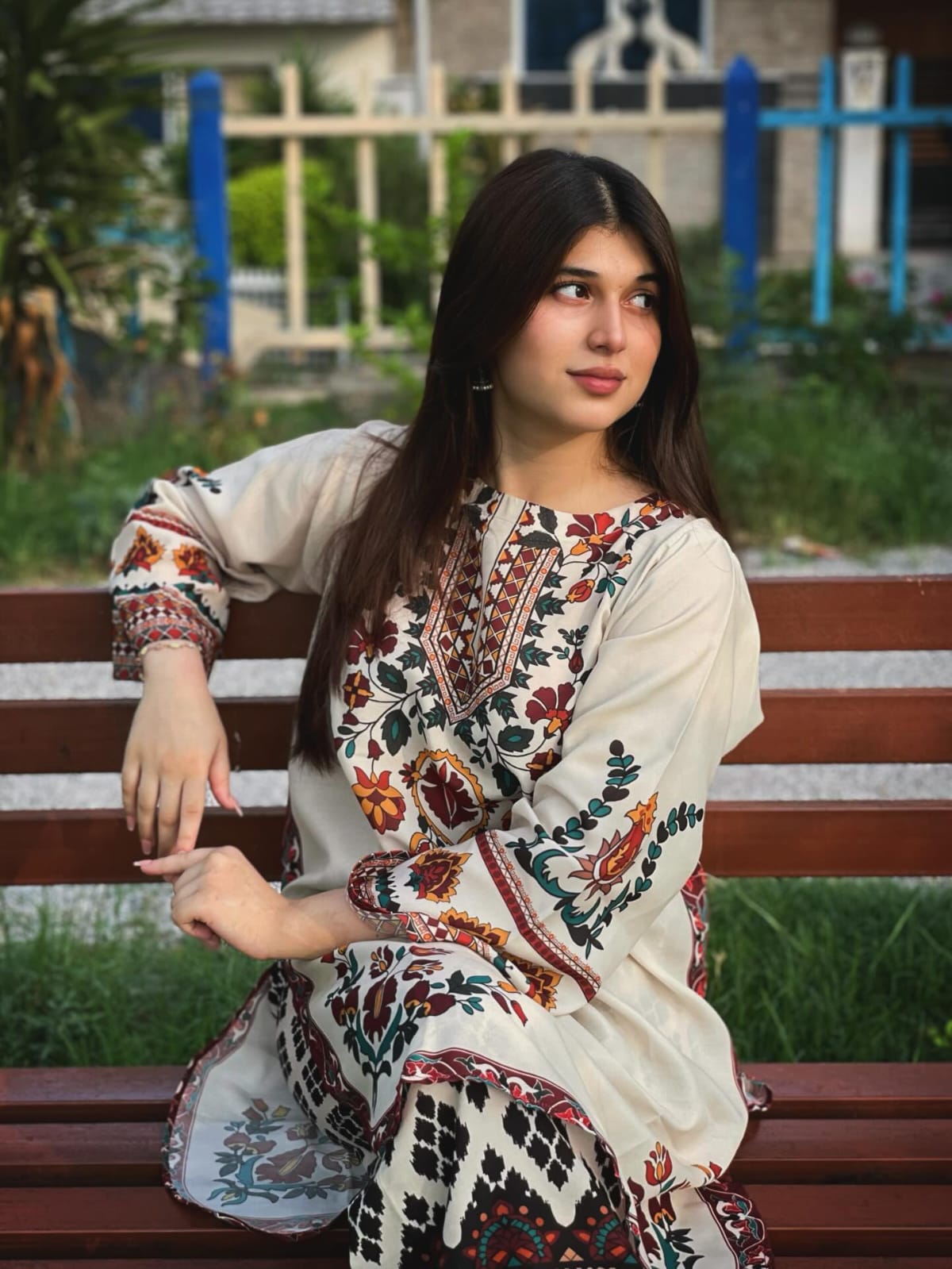 Woman in Floral Embroidered Kurti by a Pond