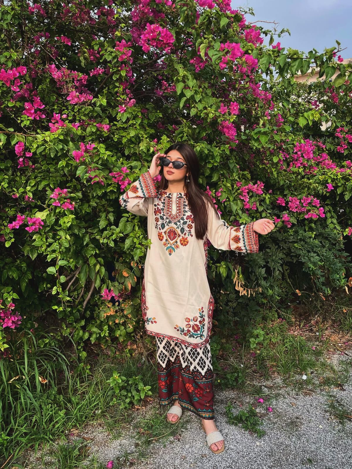 Woman in Floral Embroidered Kurti by a Pond