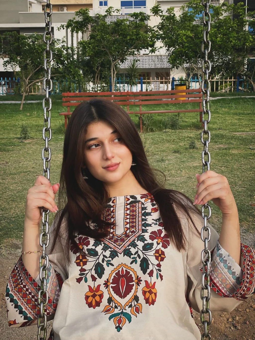 Woman in Floral Embroidered Kurti by a Pond