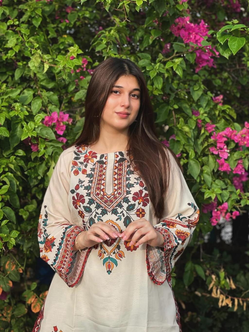 Woman in Floral Embroidered Kurti by a Pond